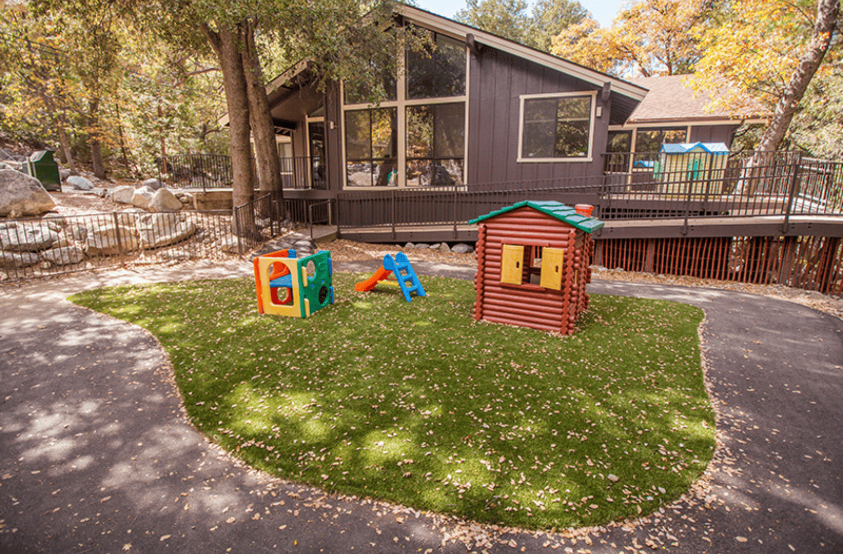 Outside of Chipmunk Corner with grass patch and kids toys on the grass